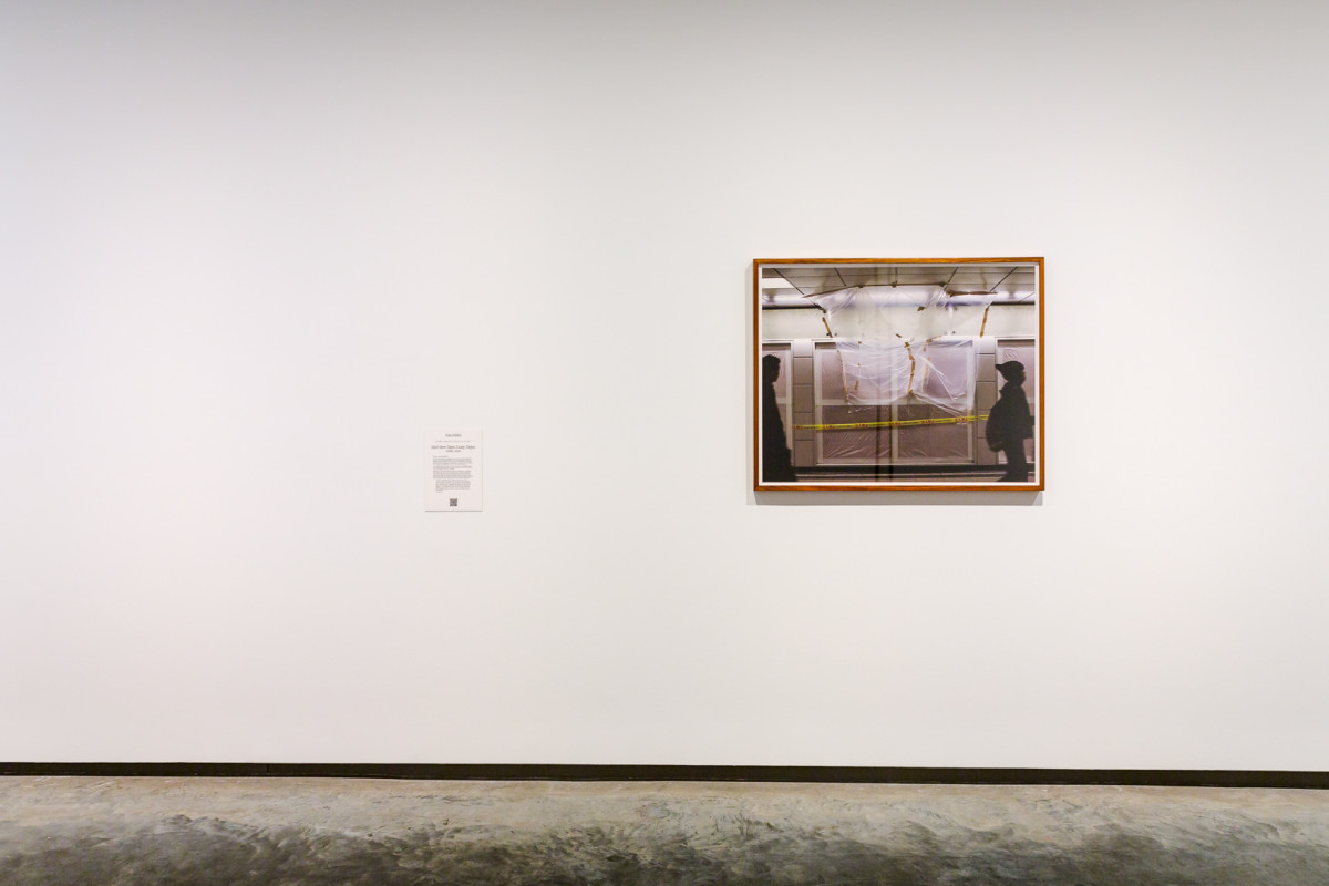 One framed photograph hangs on a white wall.