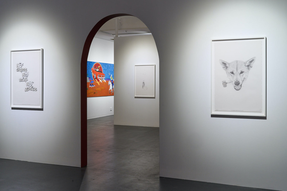 View of four artworks hanging on various walls within the gallery space.