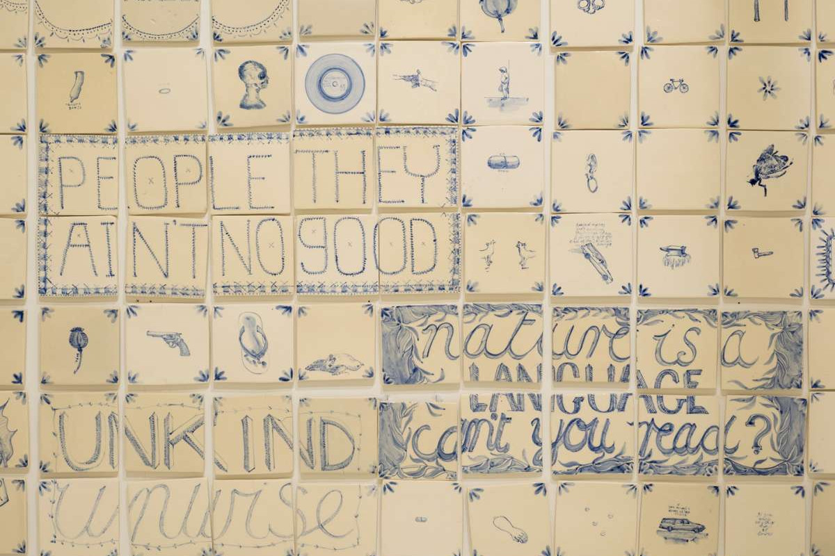 White tiles with blue illustrations and text on them.
