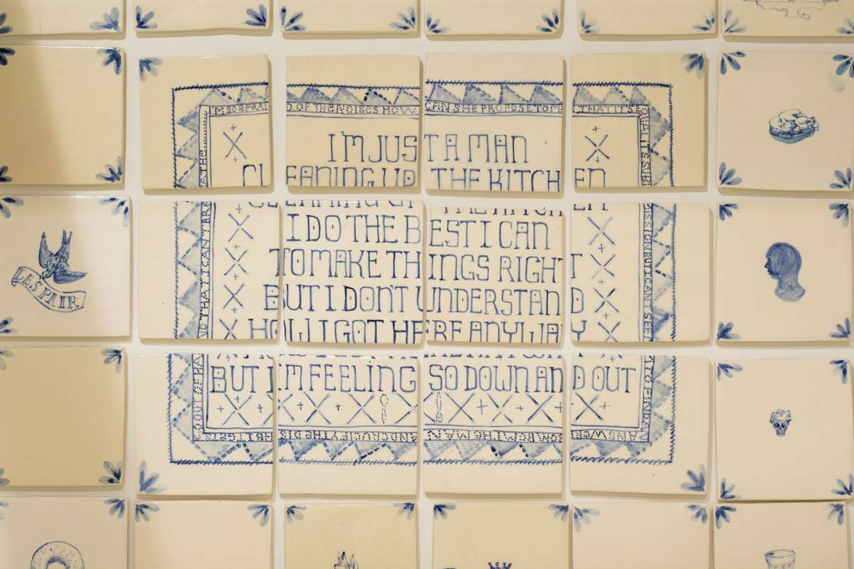 White tiles with blue illustrations and text on them.