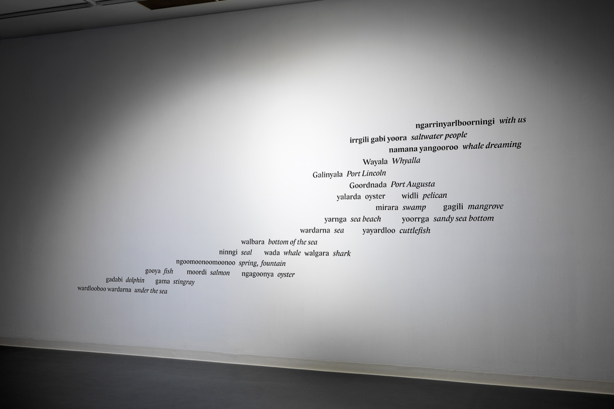 Collection of words and phrases printed on a wall in serif font.