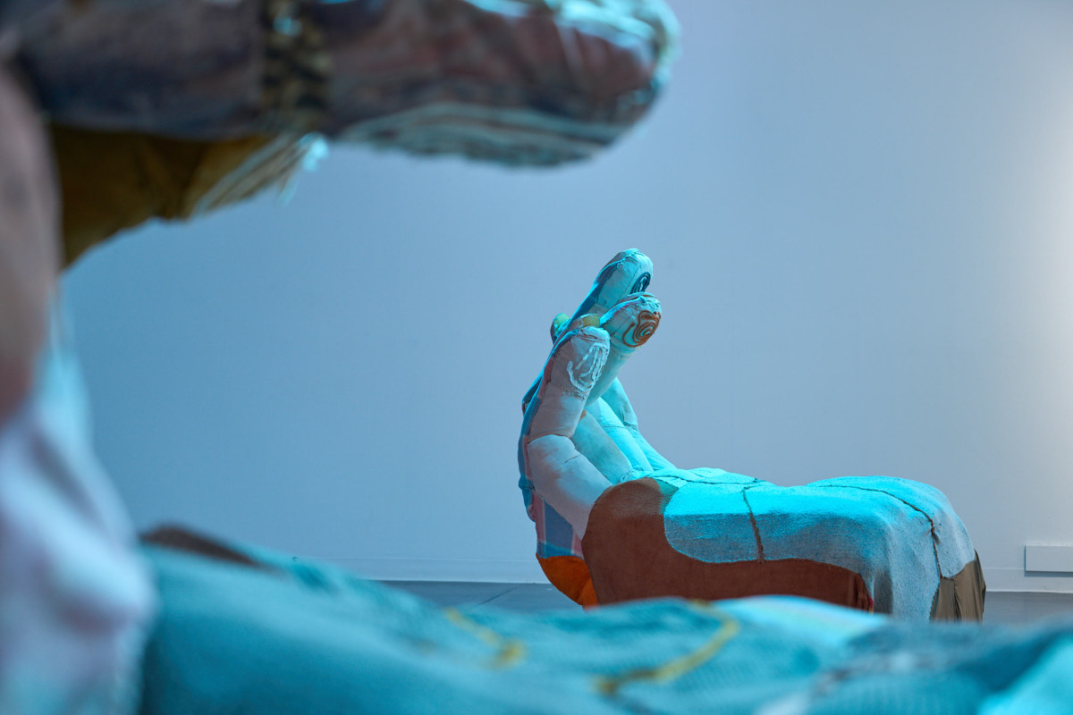 View of one of Rockamora's hands, shot through the other hand.