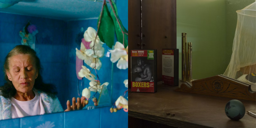 Two images side by side. Left image - a lady stands in a blue bathroom mirror with her eyes closed. A small bunch of white flowers are hanging from the mirror. Right image - a close up of a bedroom dresser mirror. On the dresser - a pen, ball and video box with the word 'BOXERS' over it sit.  In the reflection - a mosquito net hangs over the bed