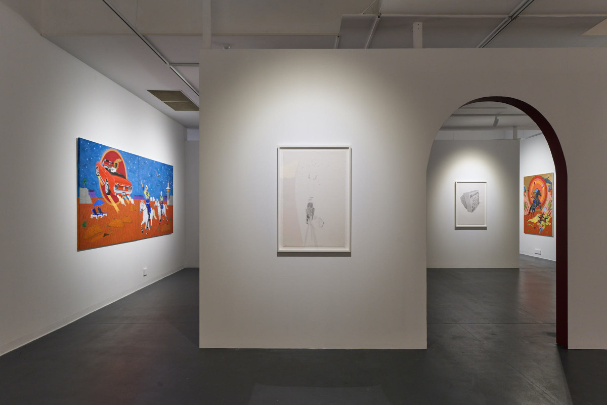 View of four artworks hanging on various walls within the gallery space.