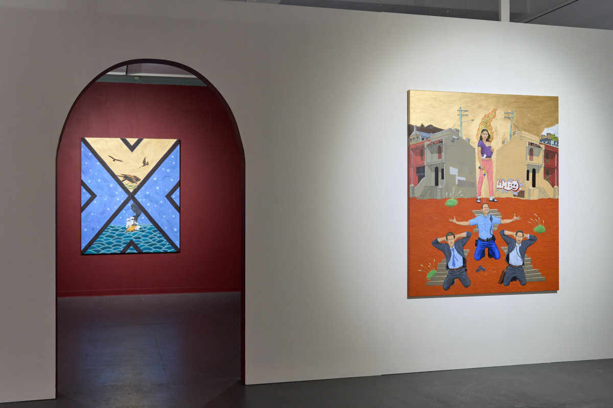View of two hung artworks at the end of the gallery space.