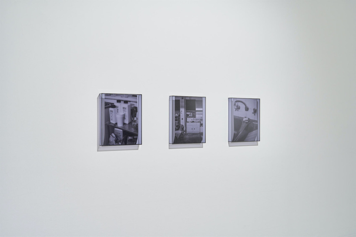 Three framed photographic works hang on a white gallery wall.