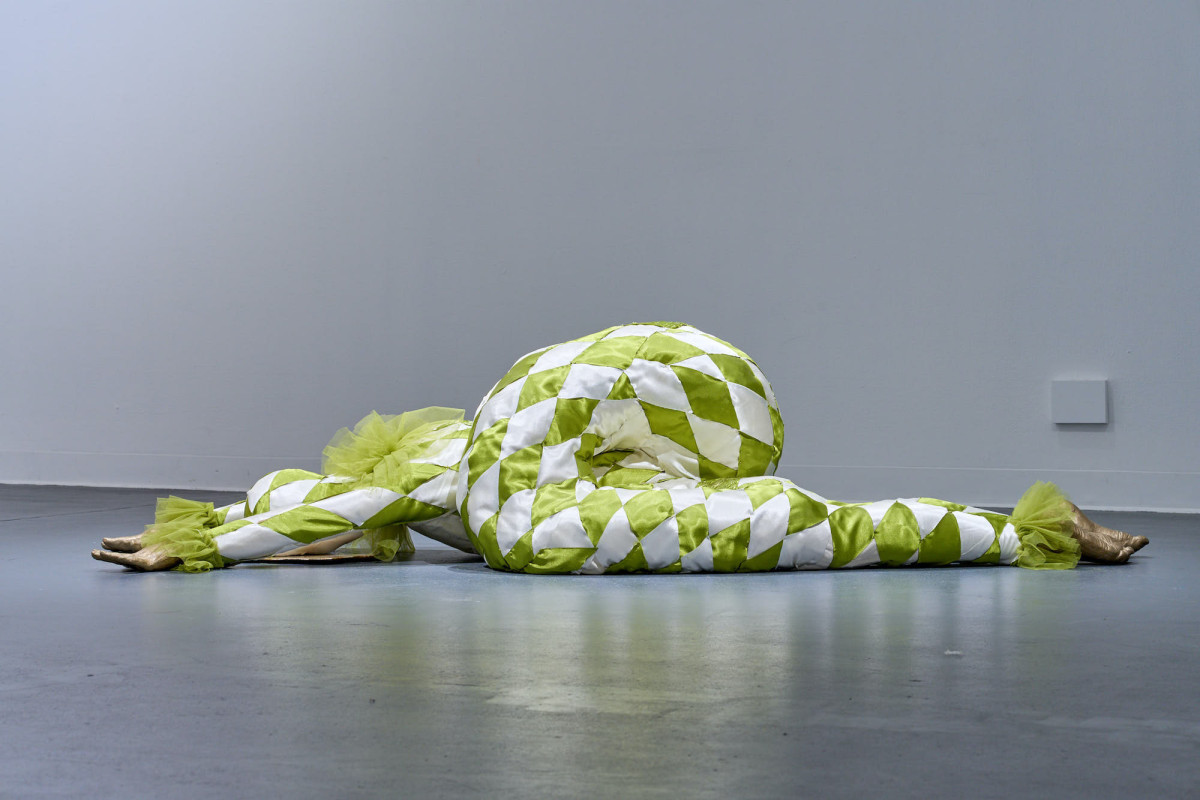 A contortionist-like form is elongated and twisted into a loop-de-loop.