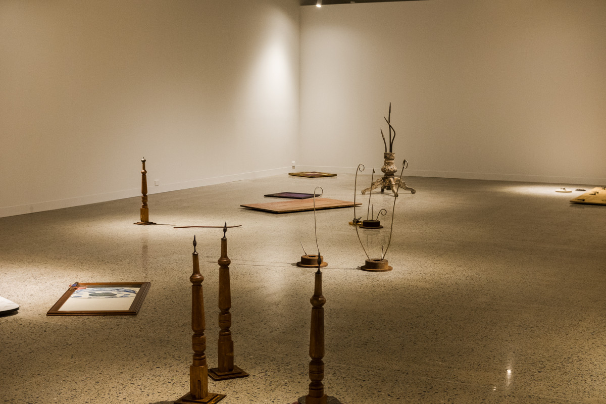 Installation view of Lee's work in the gallery. Artworks are scattered across the floor.