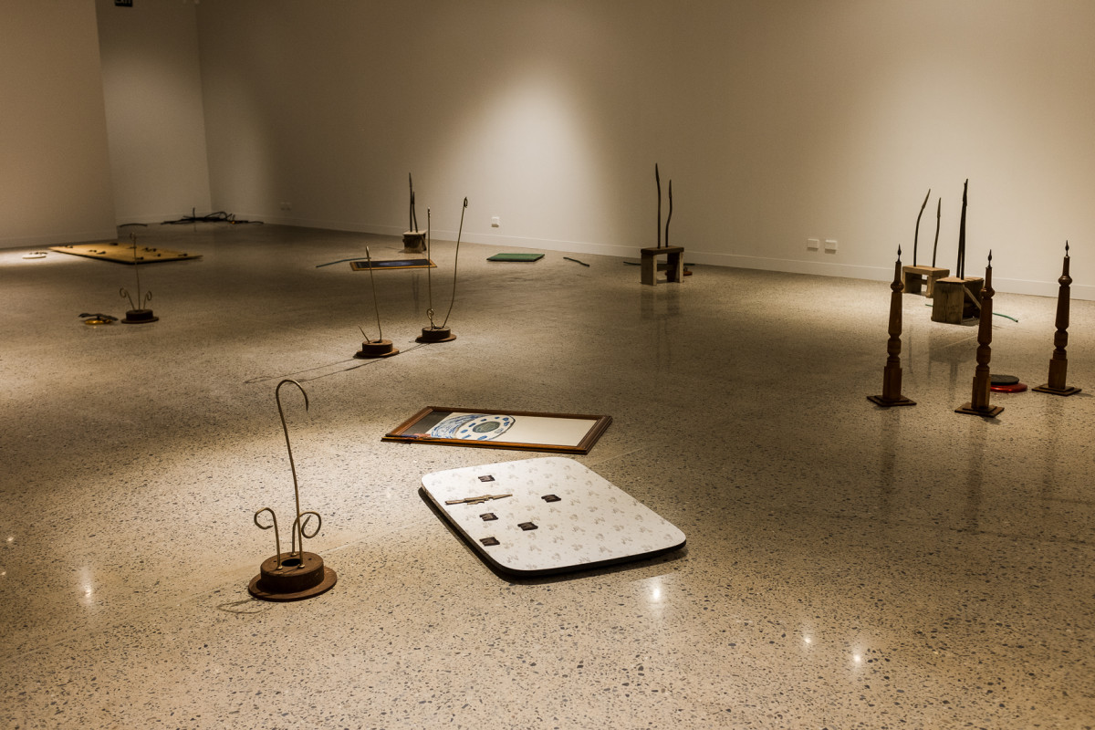 Installation view of Lee's work in the gallery. Artworks are scattered across the floor.