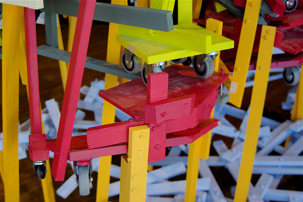 detail view multi-material and multi-coloured sculpture installed on wooden floorboards.