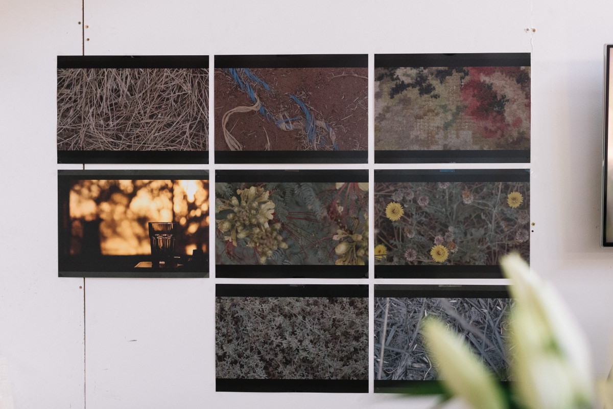 Georgia Button's studio. 8 posters pinned to wall in a grid. Stills from video work of Georgia's