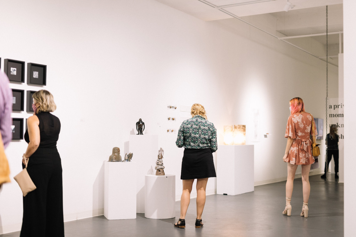 Audience views exhibition in the gallery.