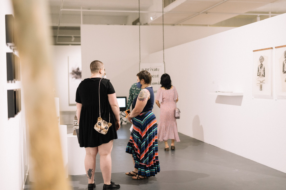 Audience views exhibition in the gallery.