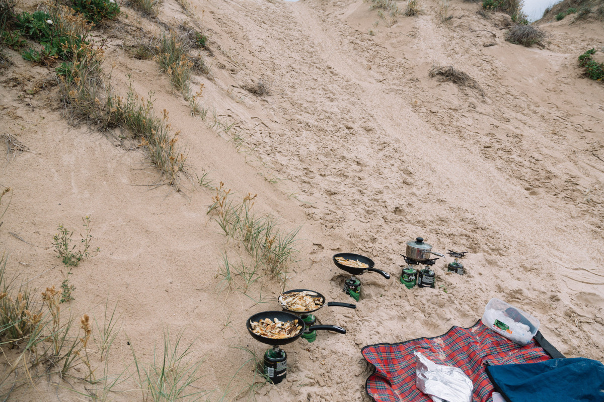Some food being booked on little gas burners in the dunes.